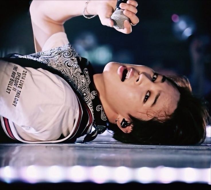 Jimin laying down on stage during concert