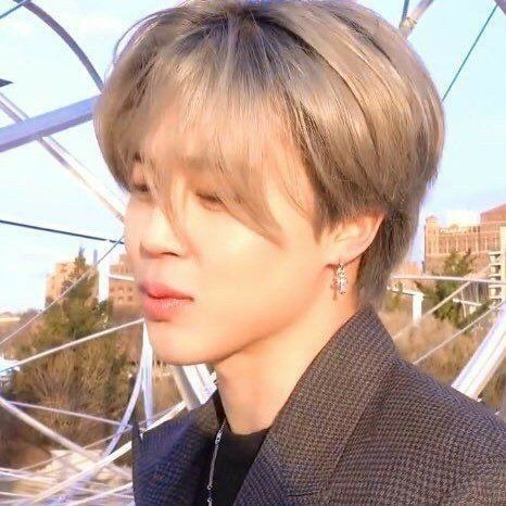 Jimin in a tweed coat, and his wind-swept blonde hair.