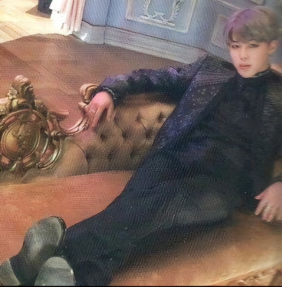 Jimin in all black suit sitting on a sofa.  WINGS photo concept book