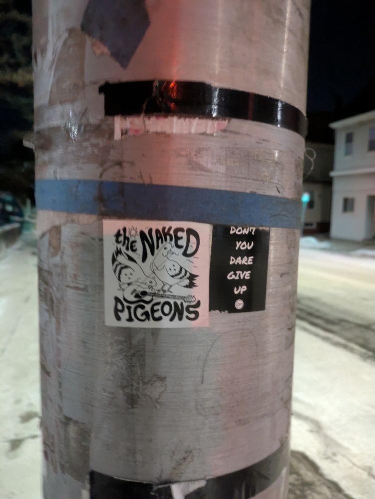 two stickers on a pole left: a 