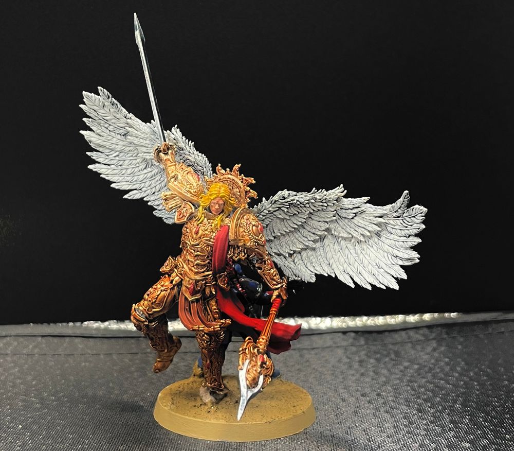 Sanguinius, primarch of the Blood Angels, wielding the Blade Encarmine and the Spear of Telesto.