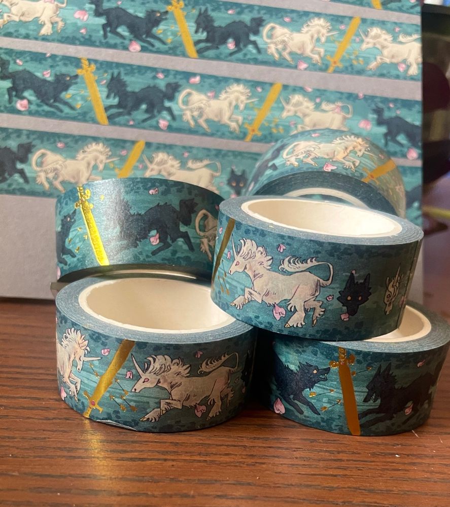 Washi tape decorated with black wolves, white unicorns and gold swords.