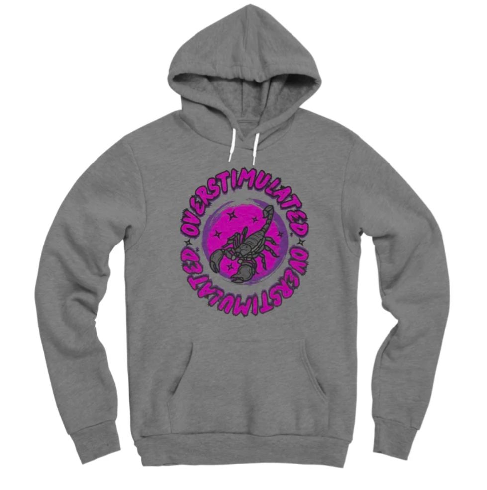 A dark heather gray pullover hoodie with a purple scorpion design and wrap around text that reads "overstimulated"