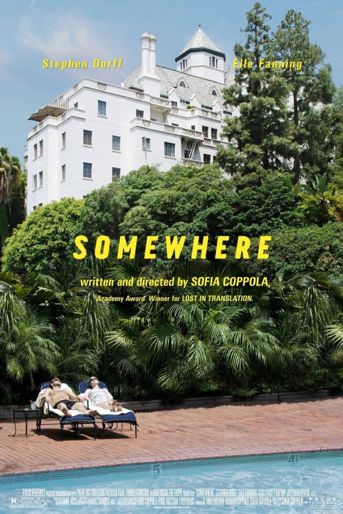 A poster for the film Somewhere directed by Sofia Coppola. The poster features two people, a man and a young girl, laying on deck chairs in front of a swimming pool. Behind them are palm trees in front of a mansion.