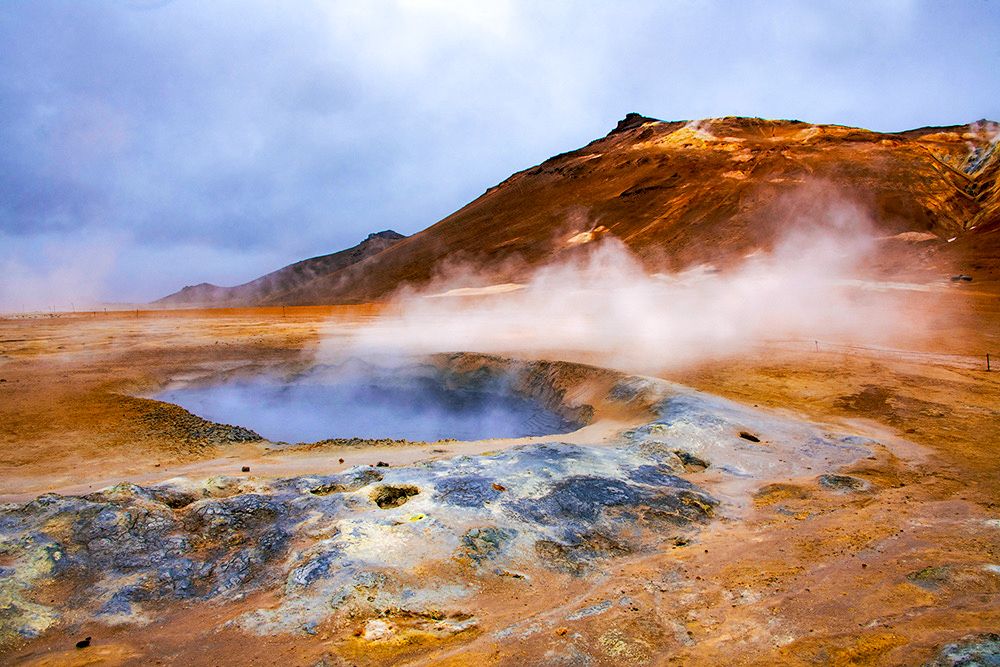 Steam comes out of a crater at Hverir Geothermal Area in Iceland 