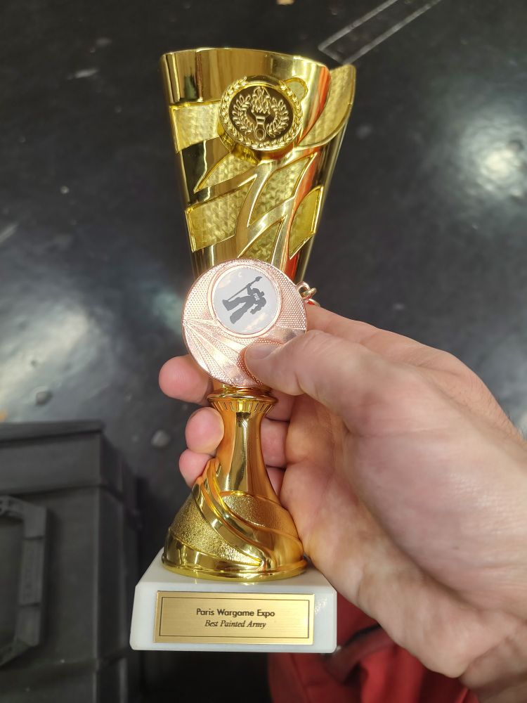 Bronze medal and gold trophy with "best painted army"