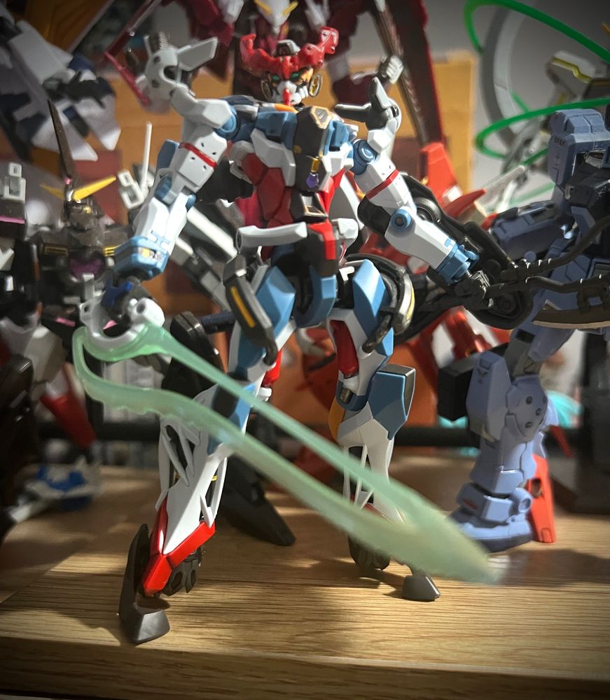 The High Grade 1/144 scale model of the Gundam GQuuuuuuX, a white, red, and blue robot that blends the styling of the classic original Gundam with the Evangelion.