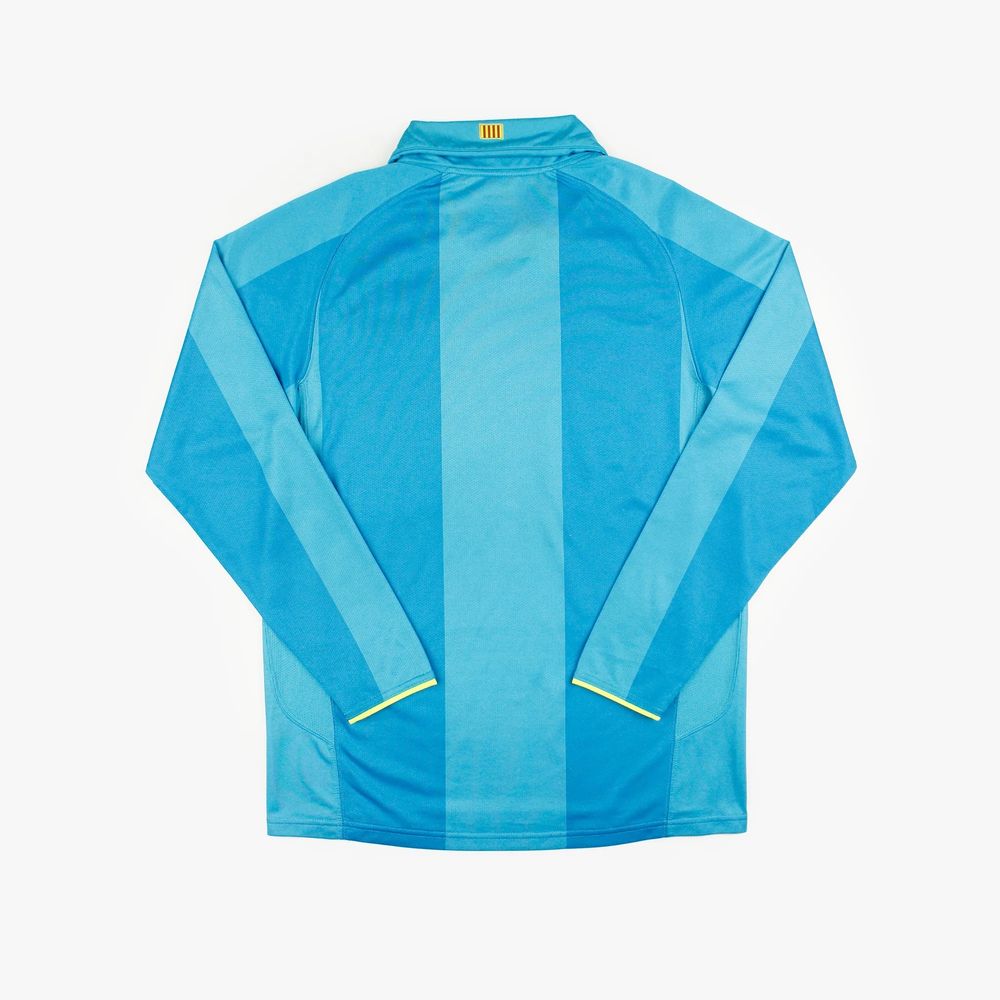 the back of a football jersey with light blue and dark blue stripes, there is no badge, name or number on the back which makes it hard to tell which team wore this unless of course you are a man who cares about fashion