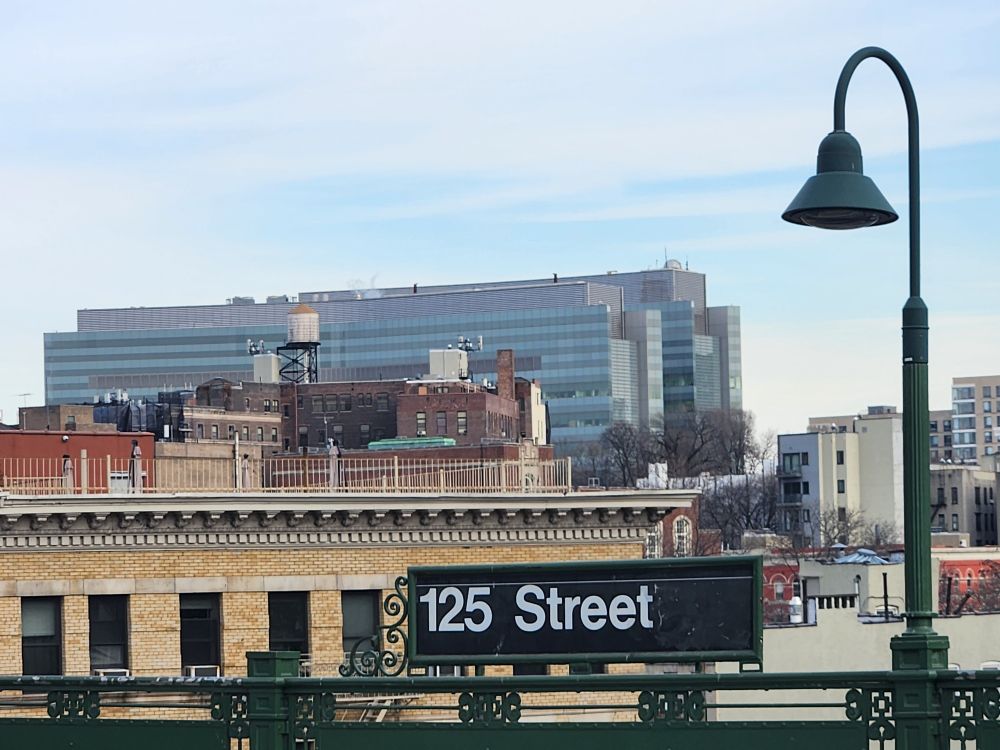 View east over West Harlem from the 125th street stop on the 1 train shows two tall building in the background (CUNY and CCNY buildings on St Nicholas Tce) with a gas sampling tower on the right hand side of the tallest roof.