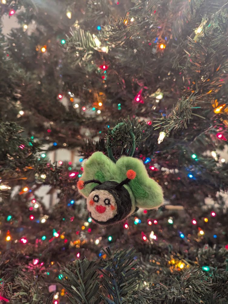 A needle felt sushi roll with bee features based off the 3D model used by Cyyuvtuber