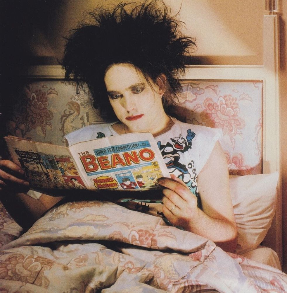 Robert Smith sat in a lovely beige bed reading The Beano
