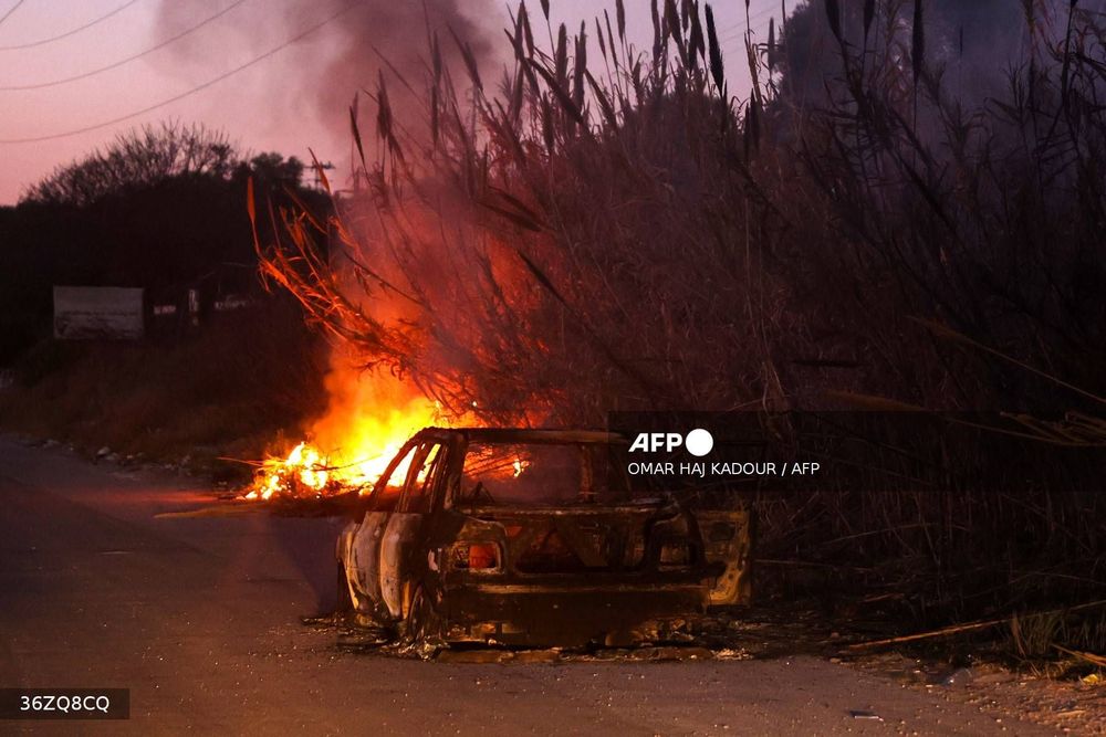 A car burns following clashes between Syria's new authorities and supporters of deposed president Bashar al-Assad near the town of Jableh in the coastal province of Latakia on March 10, 2025. The authorities on March 10 ended their sweeping "military operation" against security threats and "regime remnants" in Latakia and Tartus provinces on the Mediterranean coast, defence ministry spokesman Hassan Abdul Ghani said in a statement. 