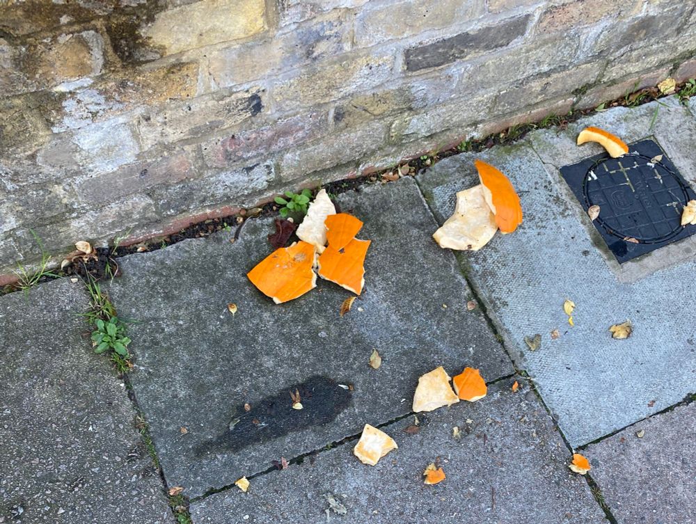 A smashed pumpkin on the pavement