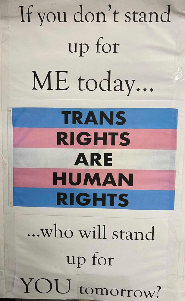 Protest sigh with trans rights flag saying "If you don't stand up for ME today, who will stand up for YOU tomorrow?"