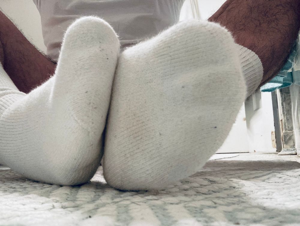 Close up of my white socked feet.