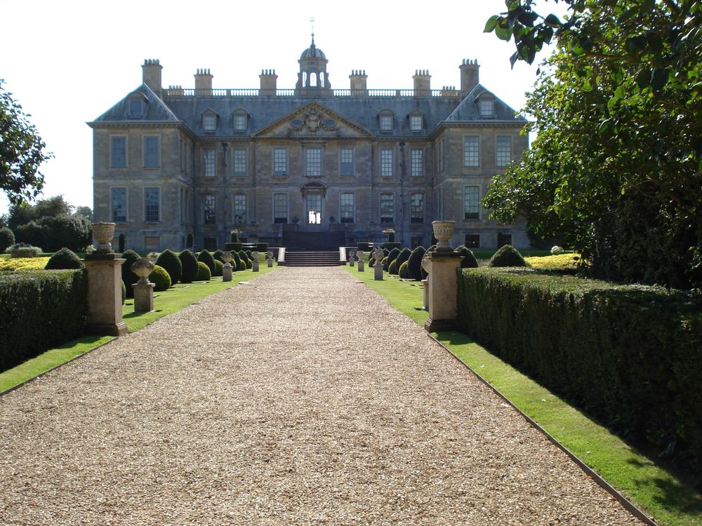 A C17th house with ornate gardens leading to the house entrance.