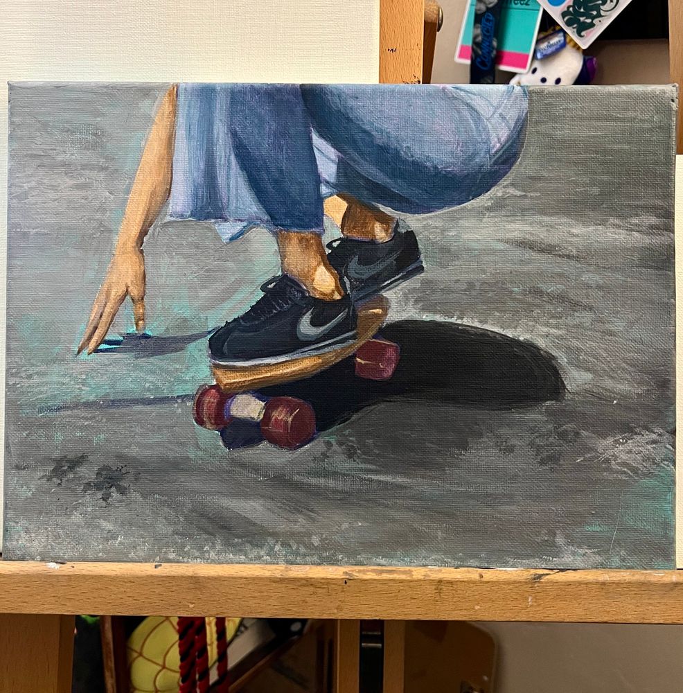 work in progress acrylic painting by Zoë Treez - 2025

on canvas, a person is painted squatting with their hand out, while cruising in a small wooden penny skateboard. the person is wearing black cortez’s and wide legged denim pants. the painting is still rough as this is just a progress shot of the painting sitting in on my easel in my room 