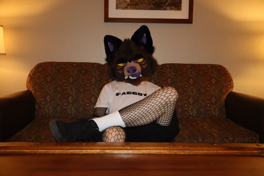 park sitting cross legged looking at the camera 