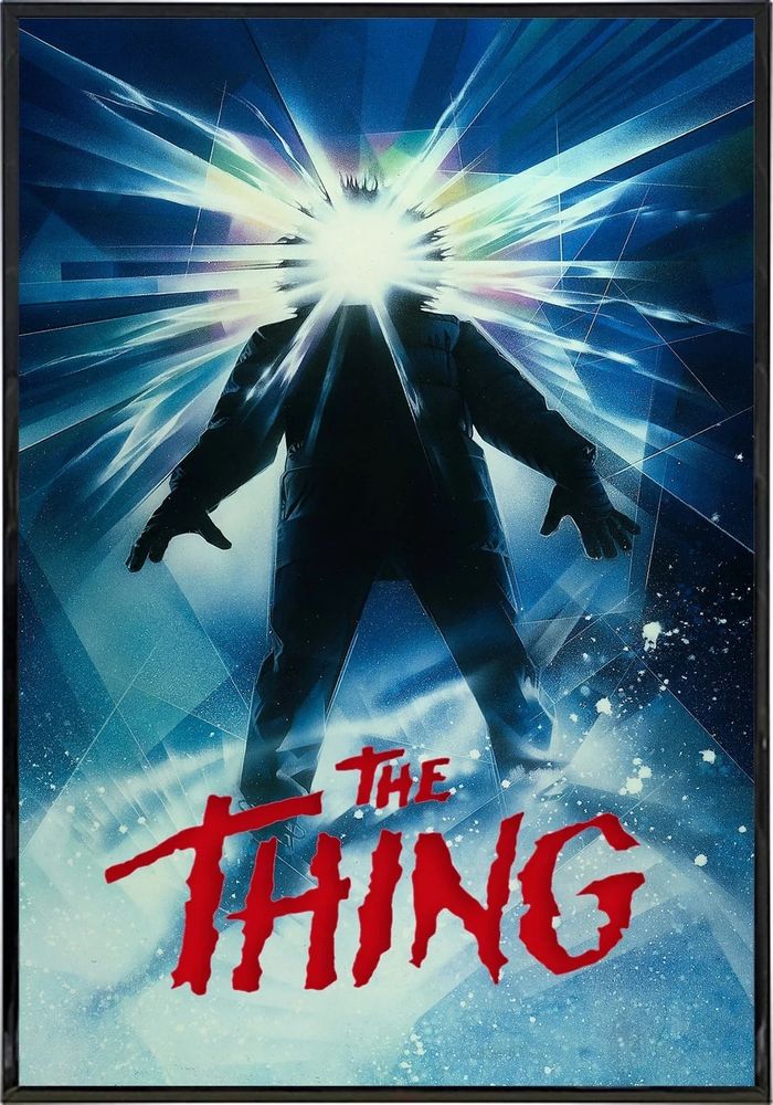 Movie poster for The Thing, featuring a hooded figure in the snow with a prism of light covering their face.
