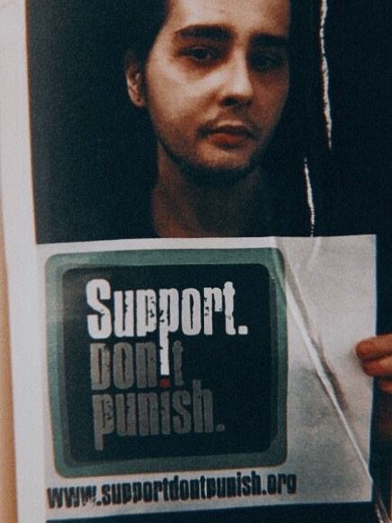 Picture of me holding a Support Don’t Punish sign 