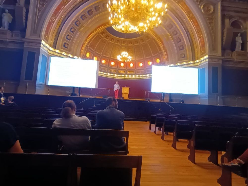 Person on a stage giving a talk to an apparently mostly empty room