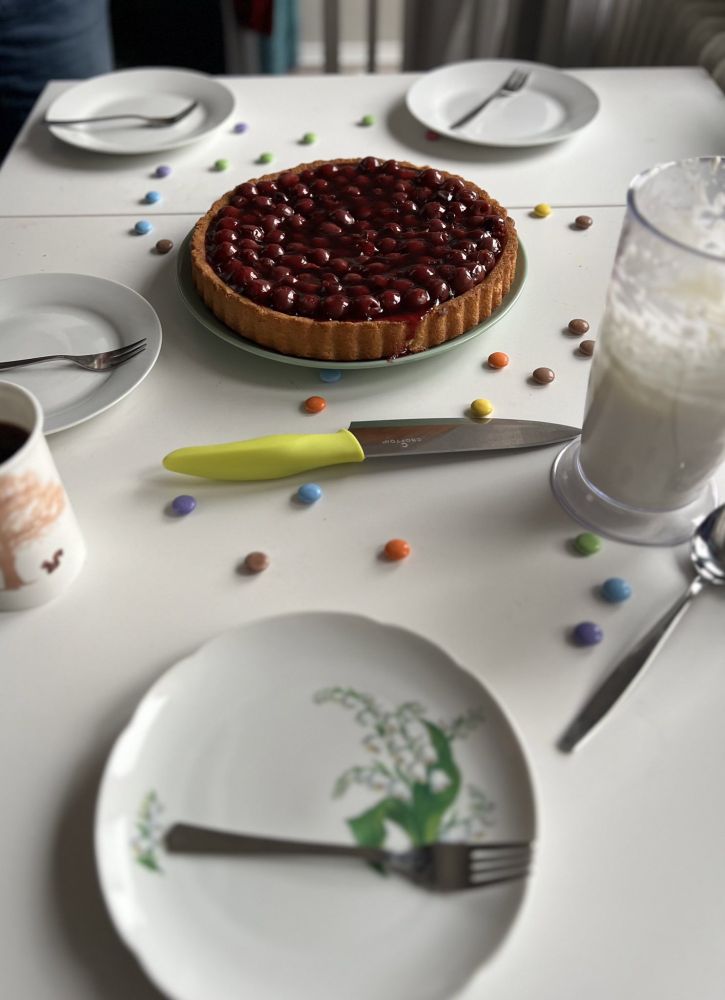 table set with smarties cherry cake and coffee
