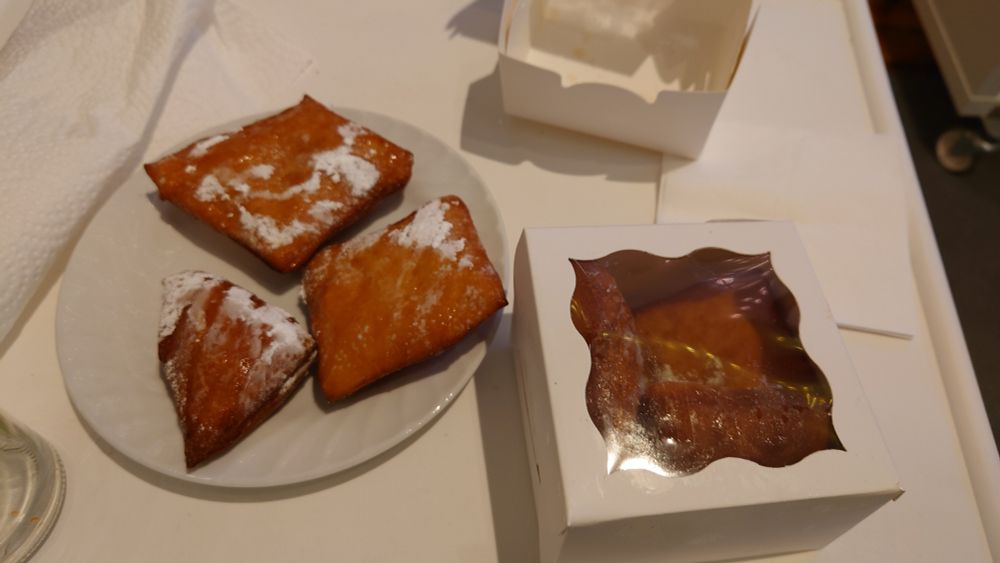 Fried dough squares with some, but not much, powdered sugar