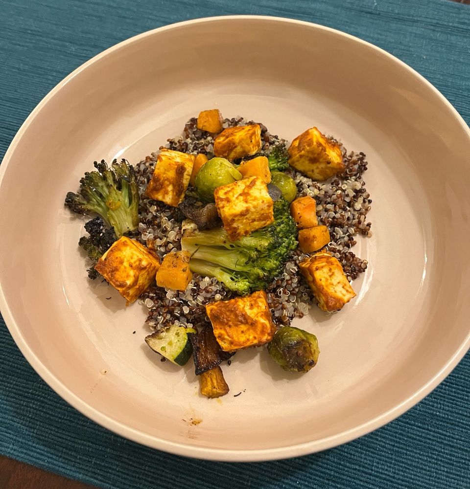 Vegan tandoori tofu quinoa bowl on a table 
