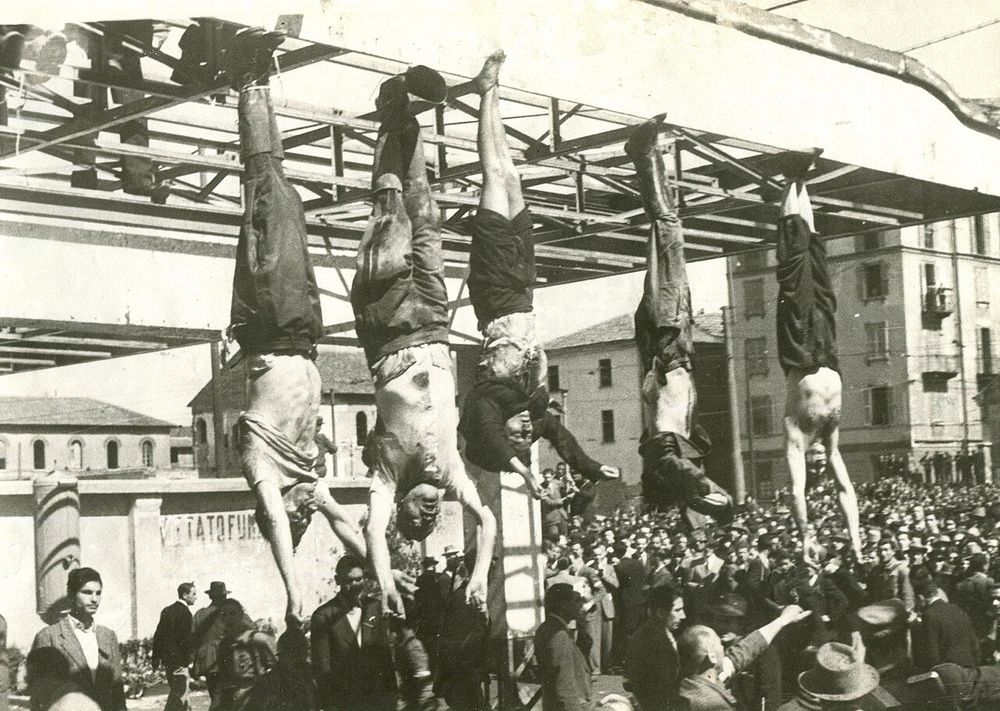 https://commons.wikimedia.org/wiki/File:Mussolini_e_Petacci_a_Piazzale_Loreto,_1945.jpg

 The dead body of Benito Mussolini next to his mistress Claretta Petacci and those of other executed fascists, on display in Milan on 29 April 1945, in Piazzale Loreto, the same place that the fascists had displayed the bodies of fifteen Milanese civilians a year earlier after executing them in retaliation for resistance activity. The photograph is by Vincenzo carrese.a AQ 