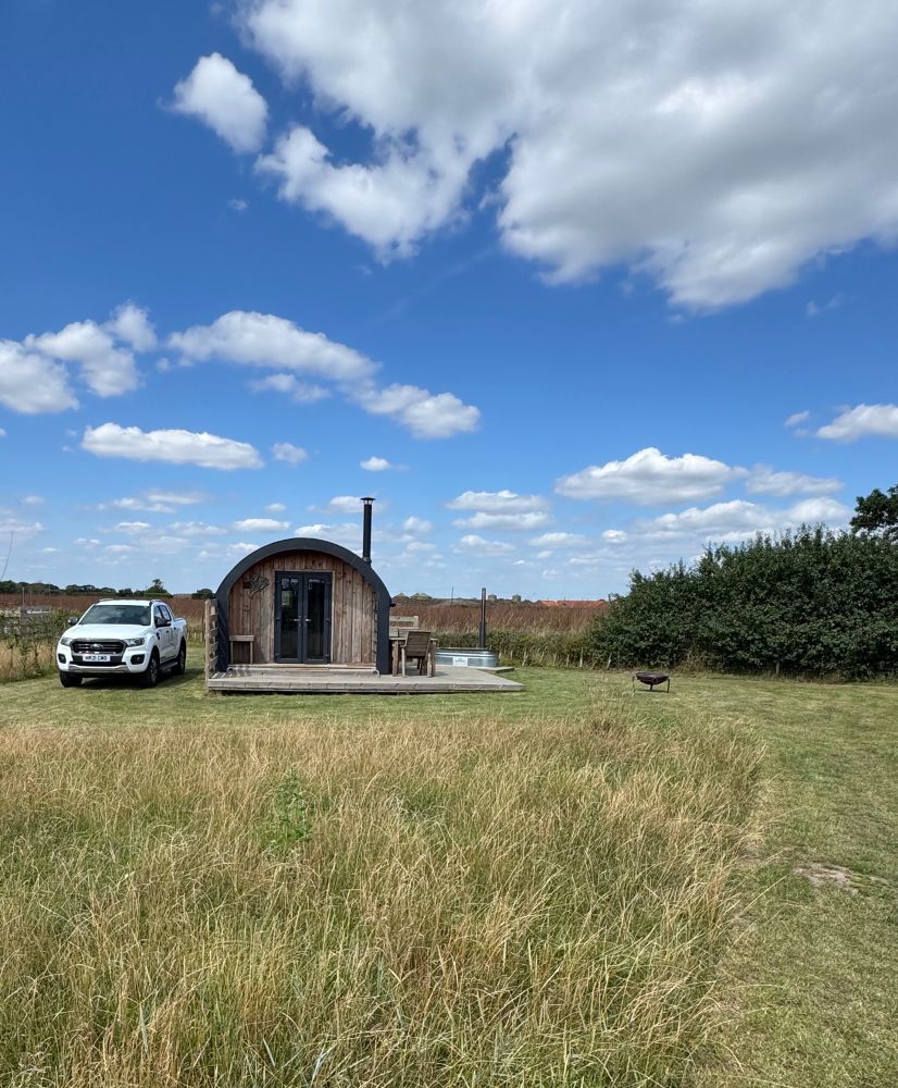 A shepherd hut in a field 