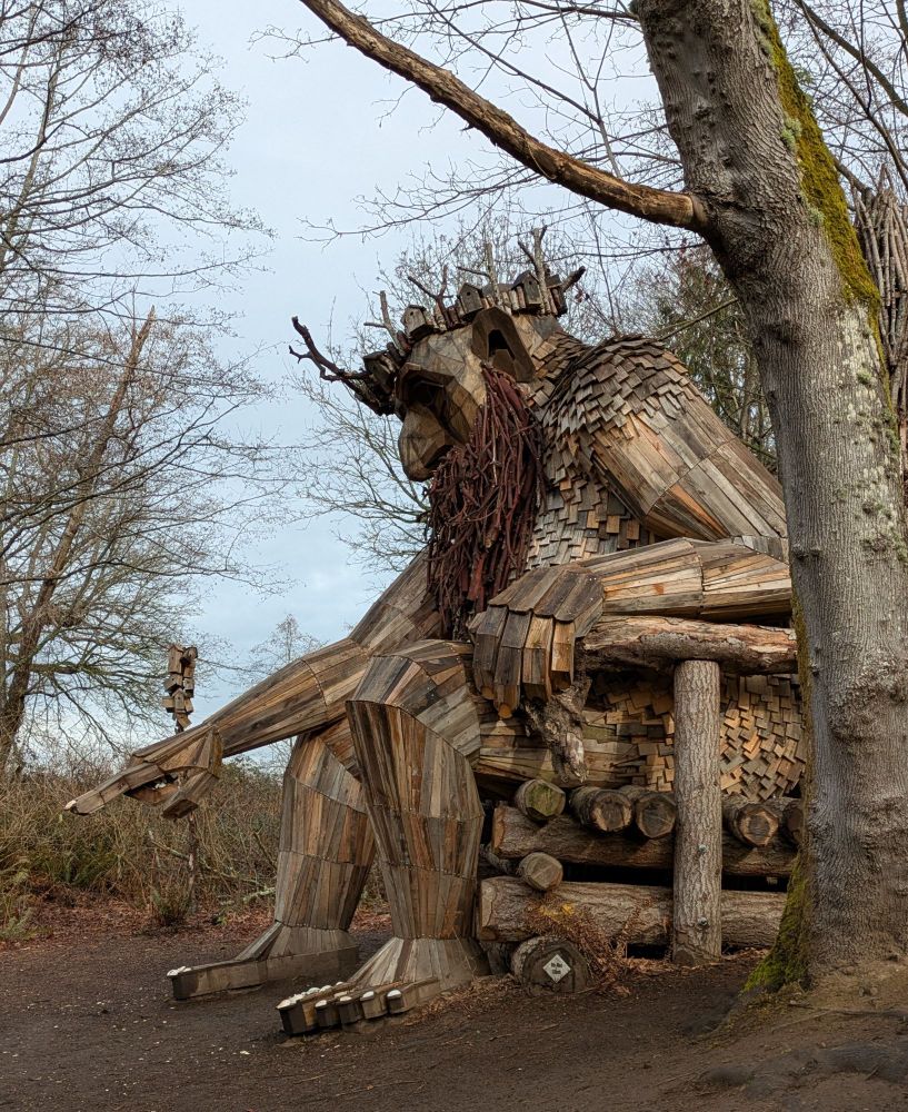 A sculpture made out of reclaimed material in the shape of a troll.