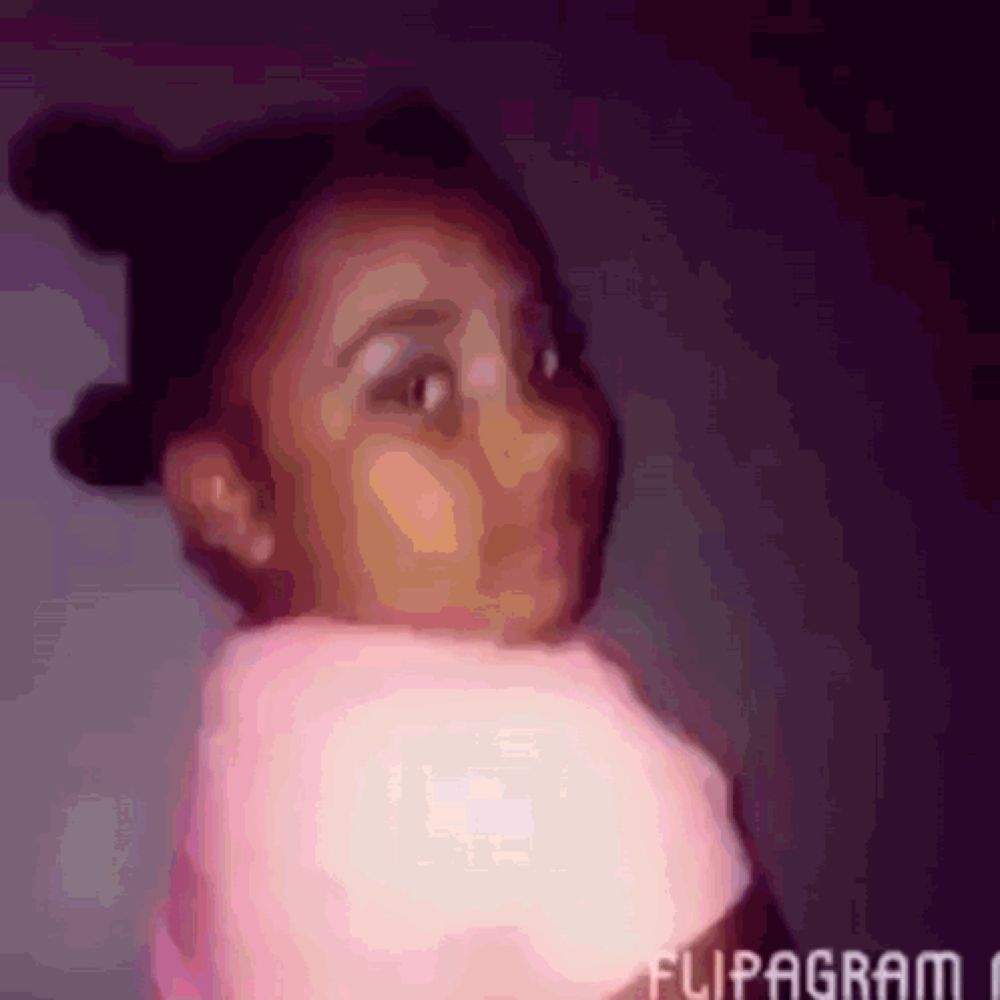 a little girl is wearing a pink sweater and a flipagram logo