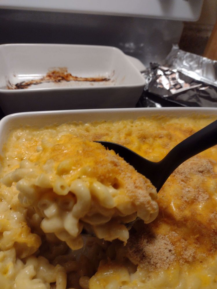 scooping up some of the macaroni look how good that lookssss. pay no attention to the gunked up kielbasa dish in the back