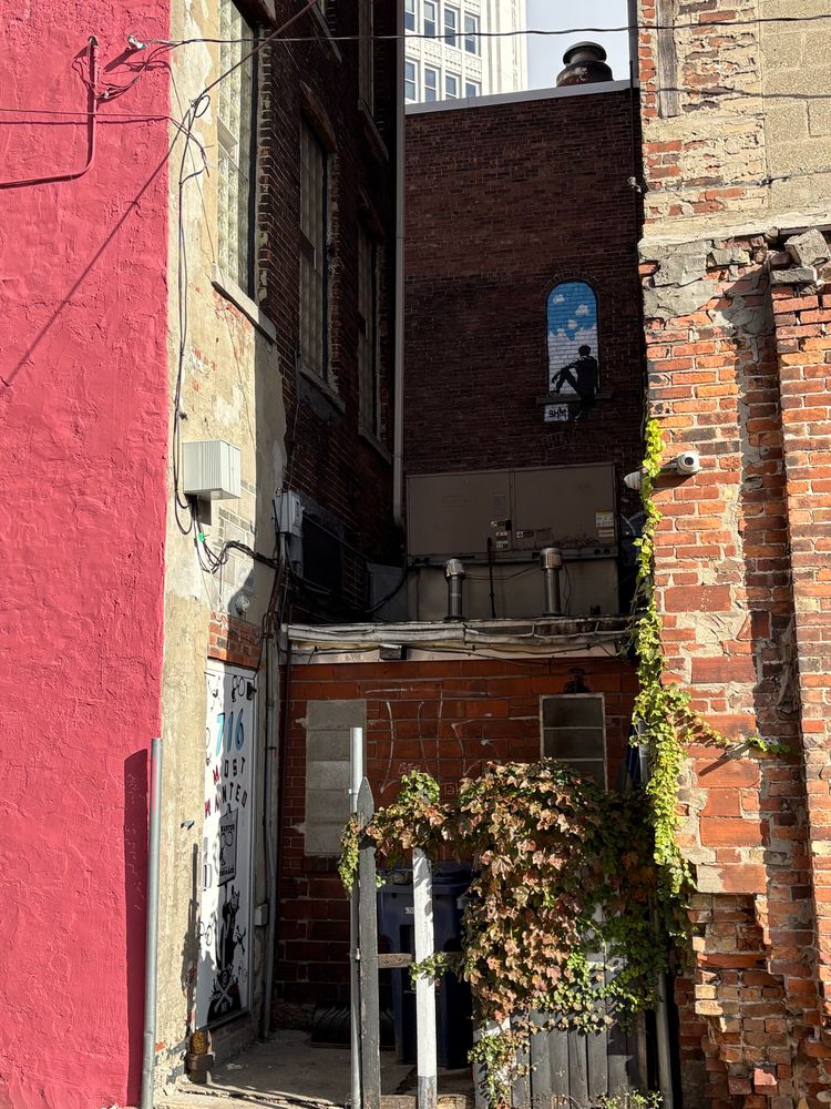 Two tags from Banksy Hates me tucked away between alleys and buildings 