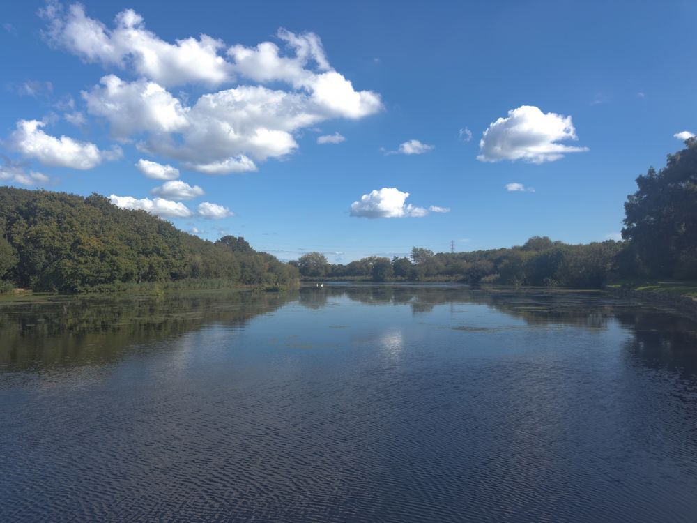 Looking down the River Exe. water lightly rippled by the breeze and a beautiful blue sky