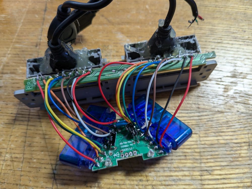 A USB adaptor for original PlayStation controllers has been soldered onto the back of a controller input from an actual PlayStation using wires in all the colours of the rainbow. 
