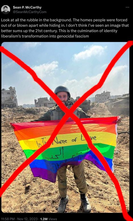 IOF soldier with a sickeningly happy smile standing in front of ruined buldings in Gaza flying a rainbow flag reading "In the name of love"
