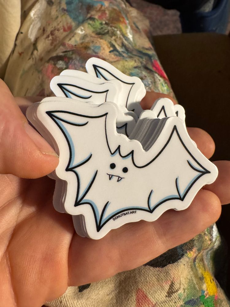 Ghost bat stickers in hand. Original illustration by Will Eskridge 
