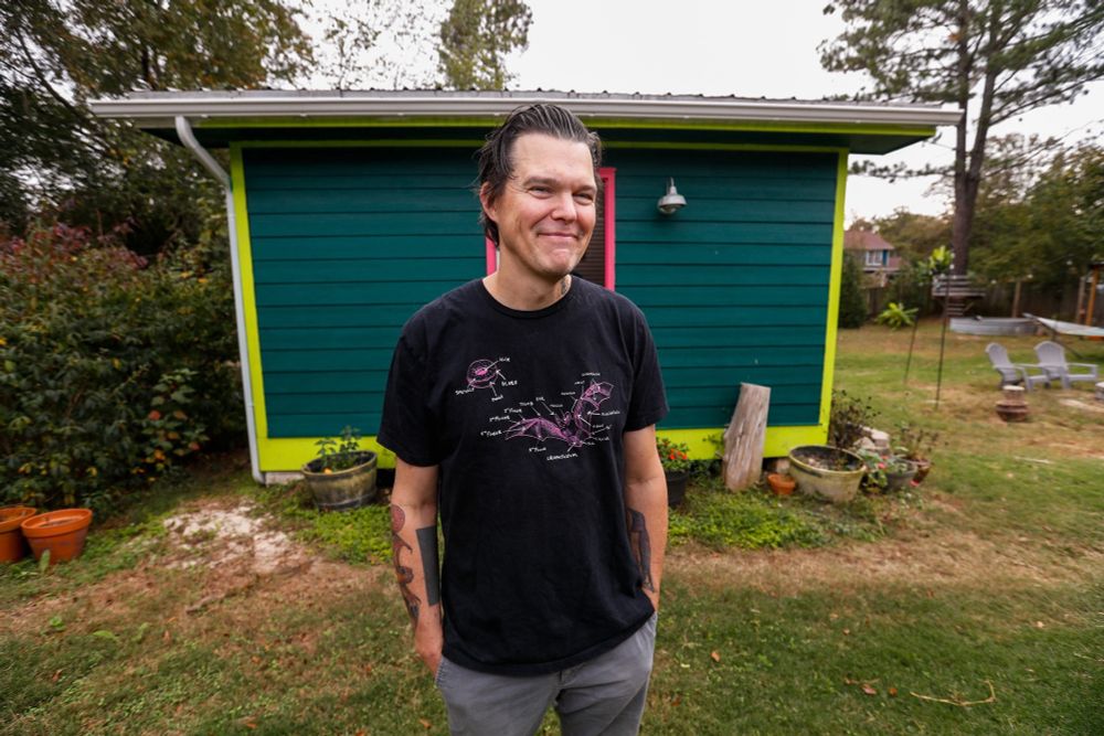 Photo of artist and muralist Will Eskridge outside his backyard studio