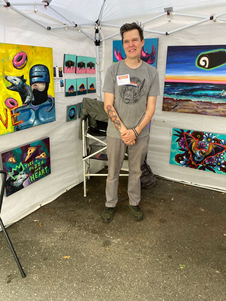 Athens artist, Will Eskridge with some of his colorful pop art paintings.