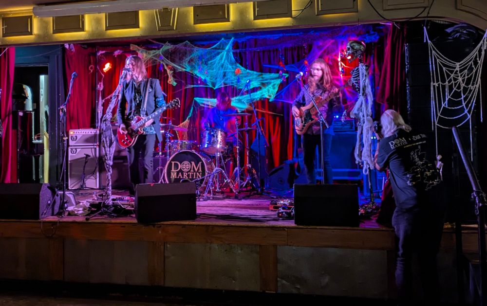 A blues rock band on stage.