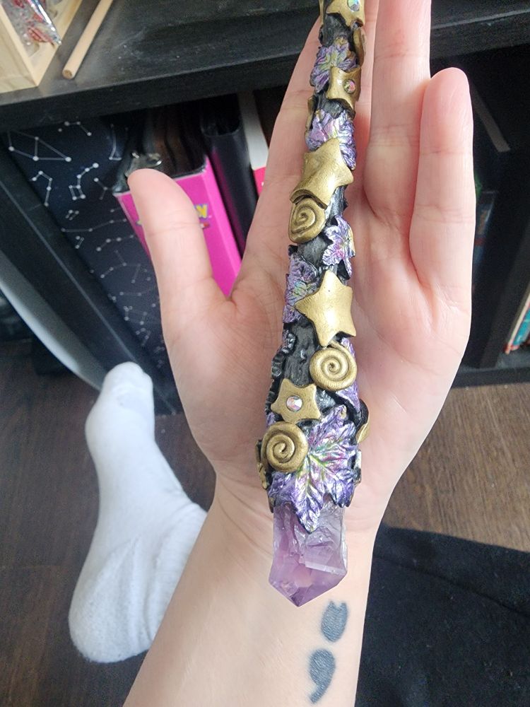 Holding the wand, close up to better show the the amethyst crystal attached at the base