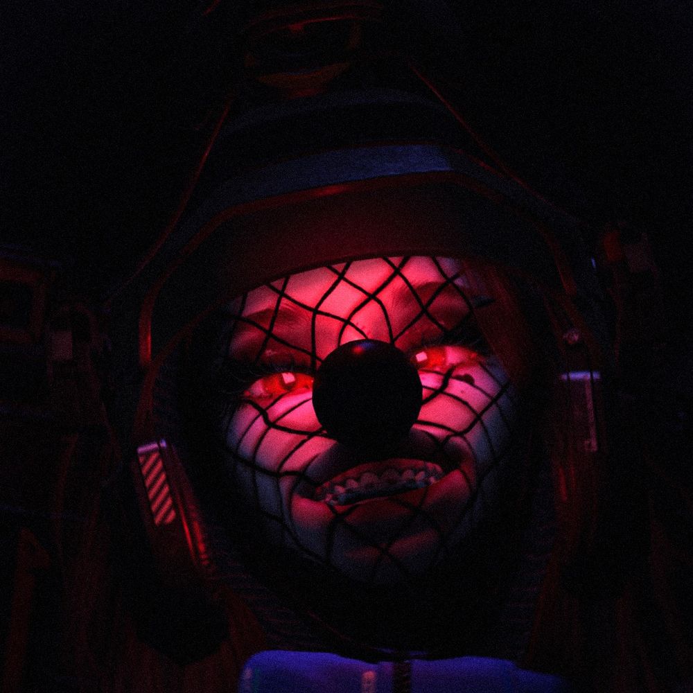 spooky militarized space clown looking down at you in the dark. smiling.