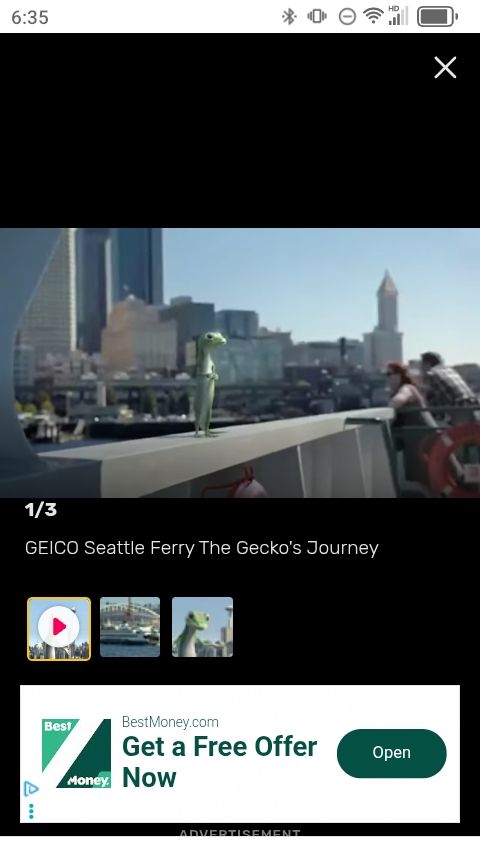 Screenshot of a GEICO commercial featuring the Gecko on the Seattle ferry 