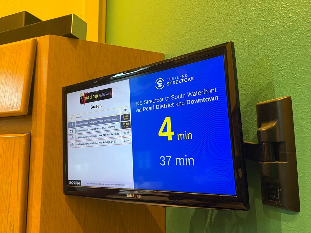 Display showing a train is due in four minutes in the hotel lobby
