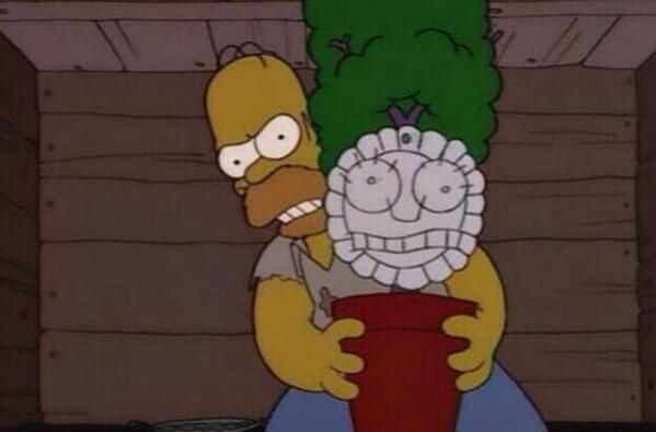 Homer Simpsons angrily holding a plant with a paper plate for a face demanding that his kids respect their new mother.