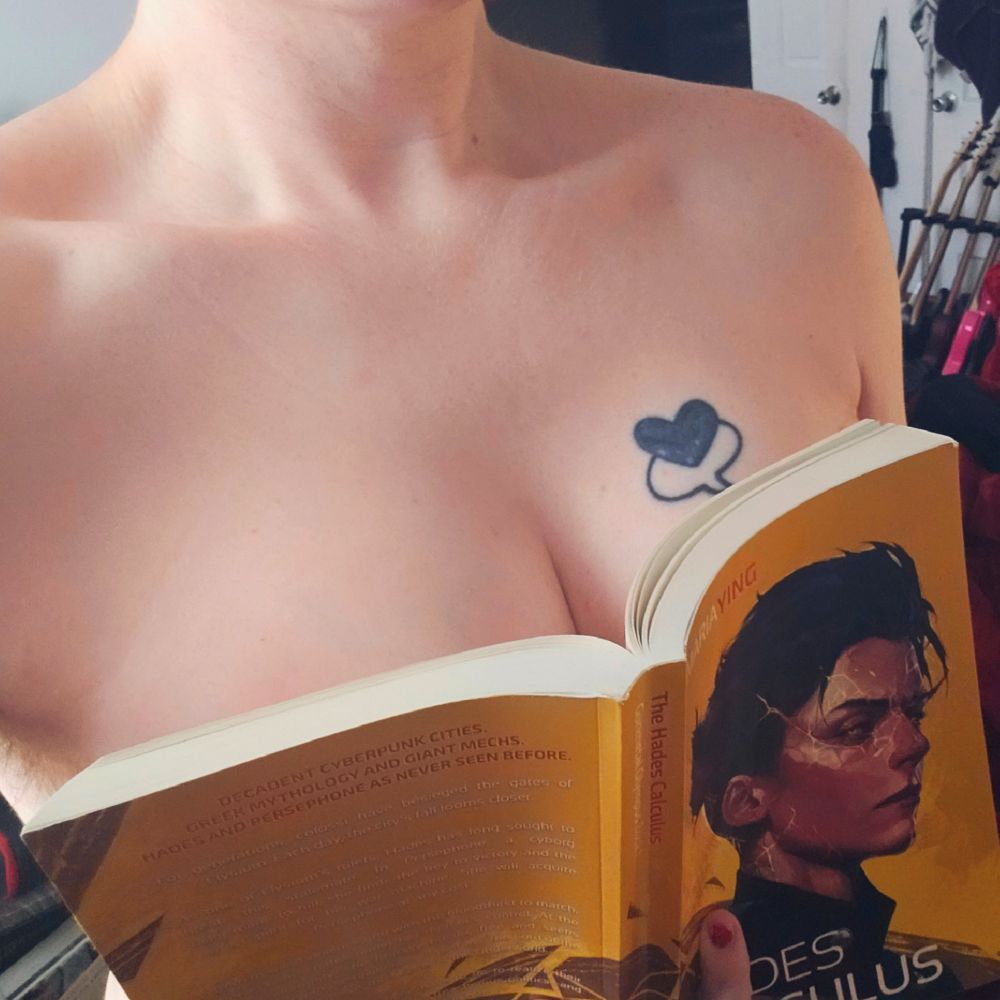 Woman's boobs covered by copy of the hades calculus