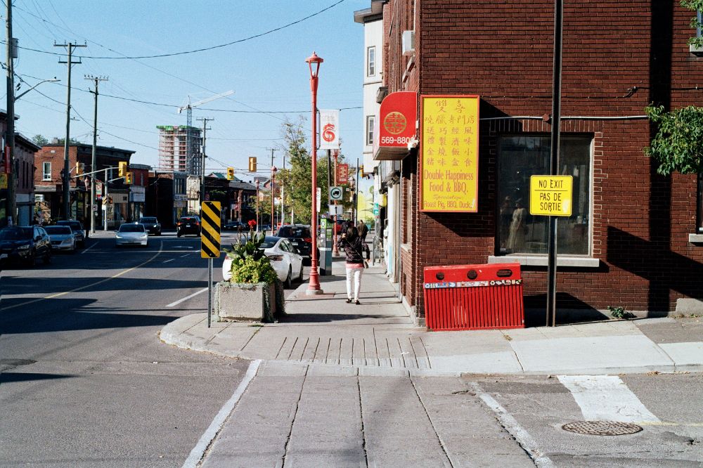 Street corner from the opposite side of the cross-street. The business on the corner is called Double Happiness Food & BBQ. 