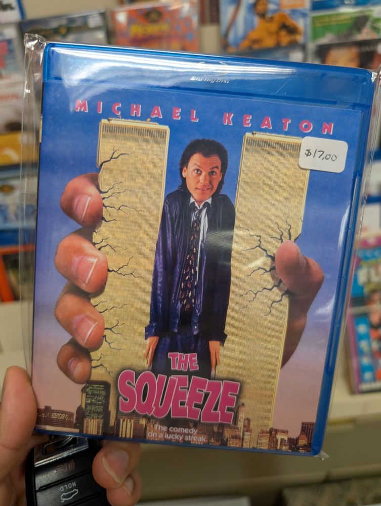 A Blu-ray box of Michael Keaton as a giant smashing the World trade Center with the palm of his hand 