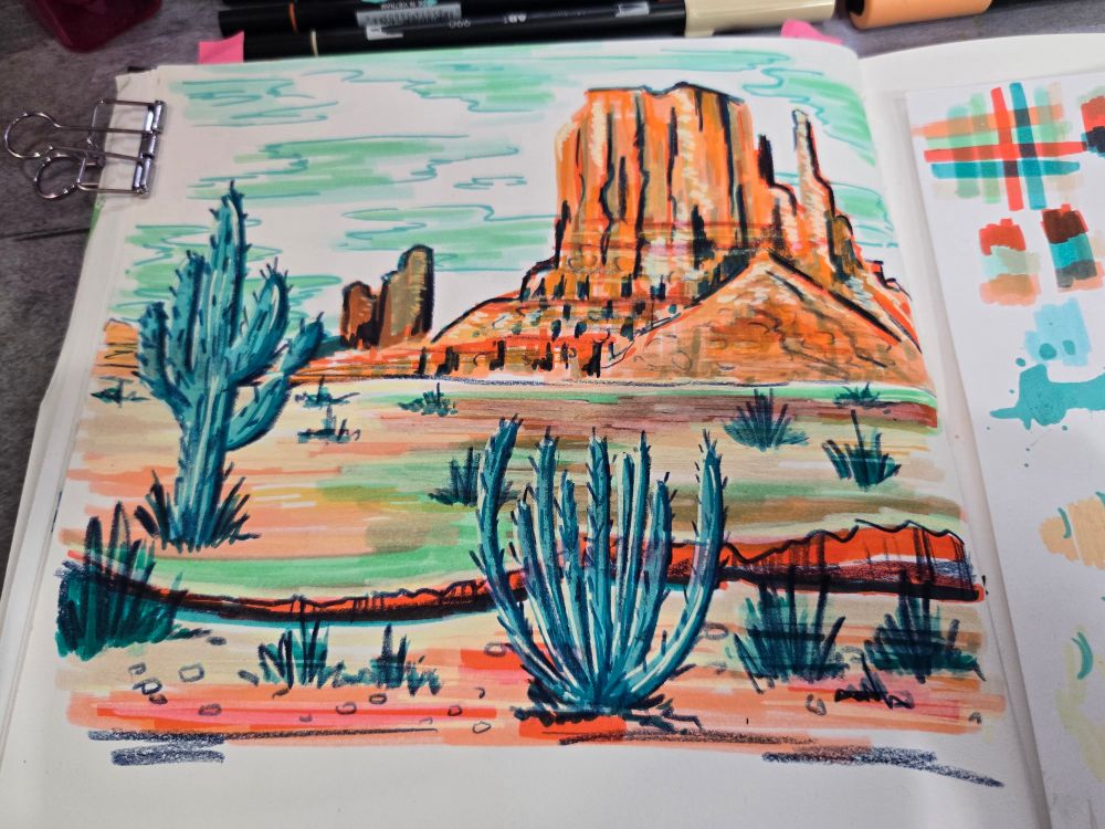 Landscape drawing in color of Monument Valley with cacti in the foreground. Picture used orangish coral colors and teals with Indigo colored pencil details.